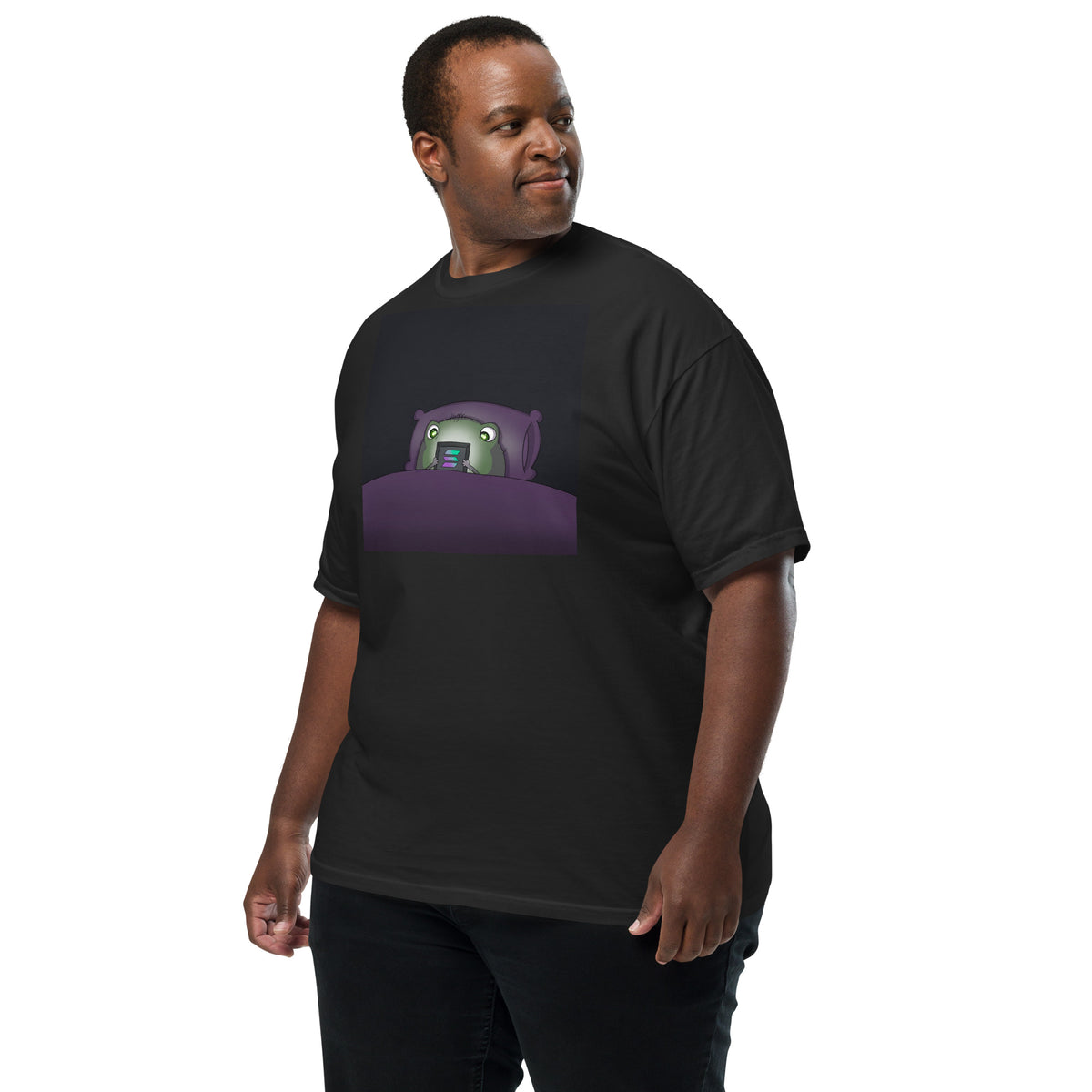 2 A.M. Pistacio black heavyweight t-shirt front view — frog in bed checking phone graphic